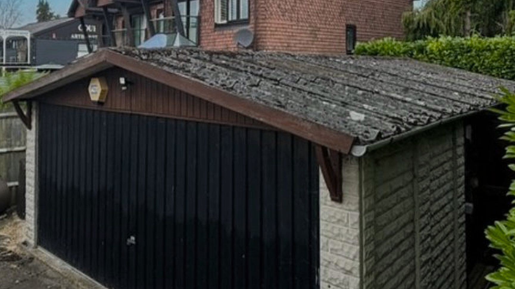 Old asbestos garage roof before replacement